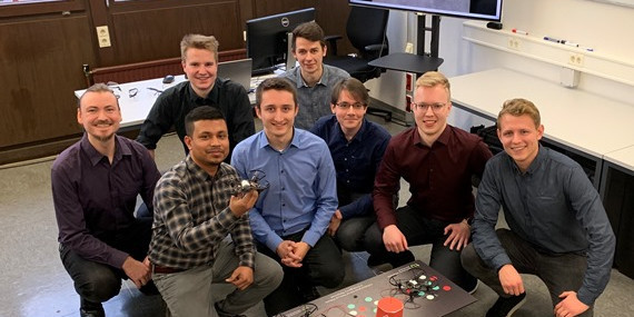 Group photo of CARE project group with a ground robot