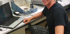 A student sitting in front of a laptop