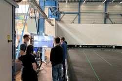 People next to a teleoperation stand