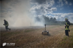Ground roboter with rescue personnel on a field