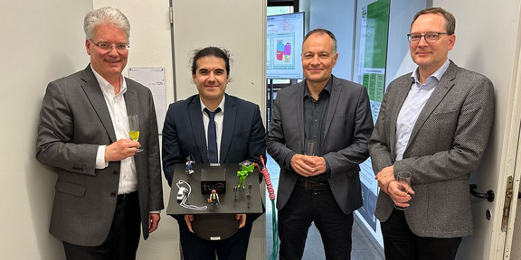 Caner Bektas and examination committee celebrates successful PhD defense.