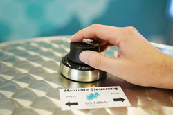 Hand on button on a desk