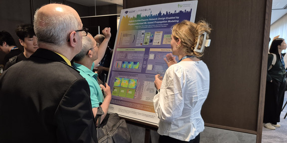 Melina Geis presenting the latest mmWave-IndoorDRaGon results at the IEEE INFOCOM 2026 poster session.